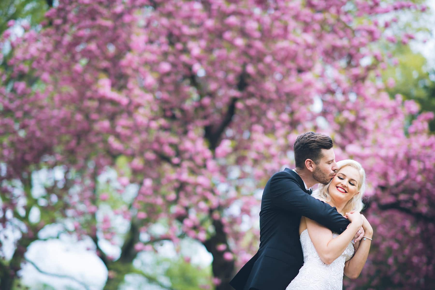 Candid elopement photography with Cherry Blossoms by Sascha Reinking