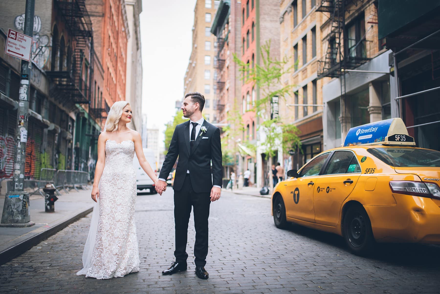 Elopement couple with NYC cobblestone streets and cabs