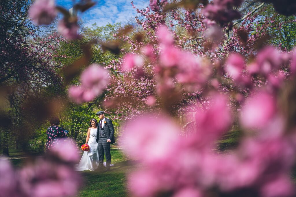 Couple getting married hand-in-hand through Central Park during a spring NYC elopement