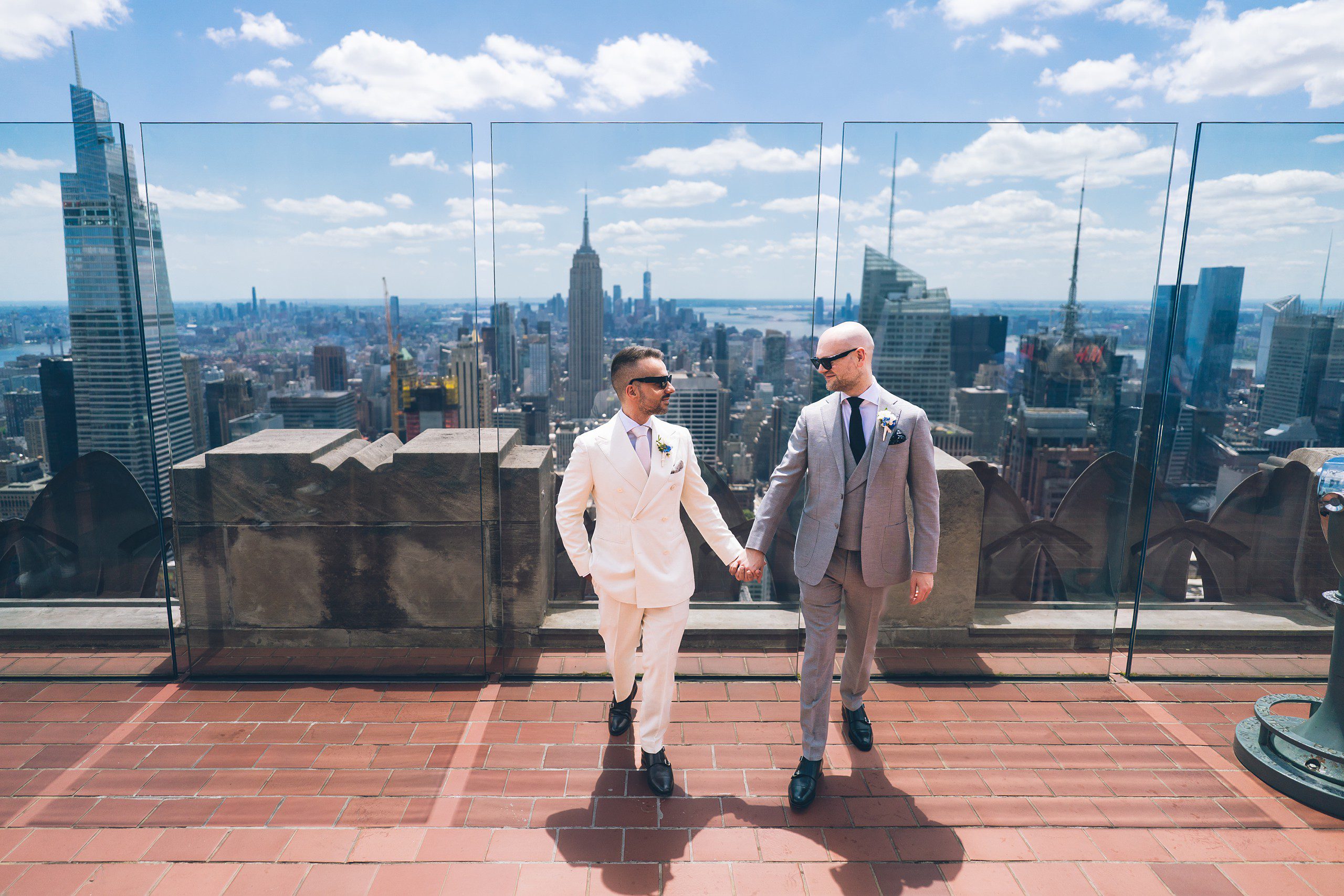 Close-up of couple holding hands at Top of the Rock rooftop ceremony officiated by Jackie Reinking.